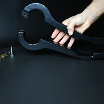 Scrotum to arms black wooden pillory