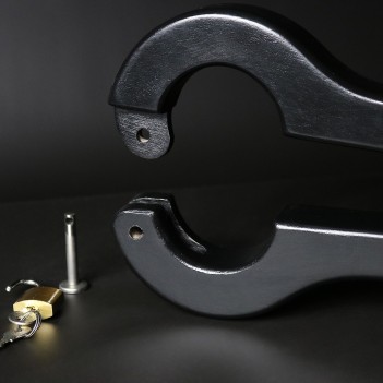 Scrotum to arms black wooden pillory