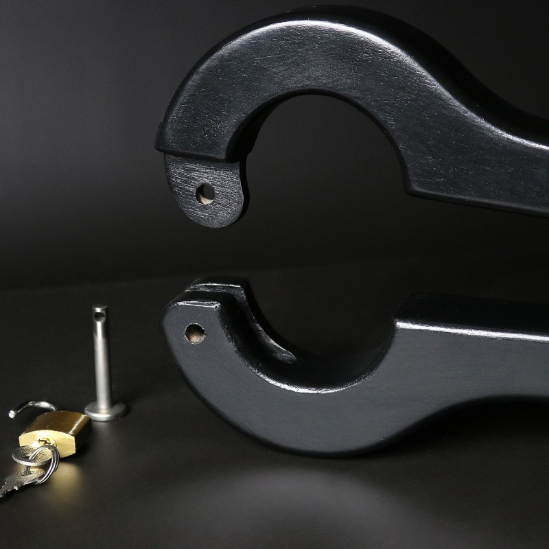 Scrotum to arms black wooden pillory