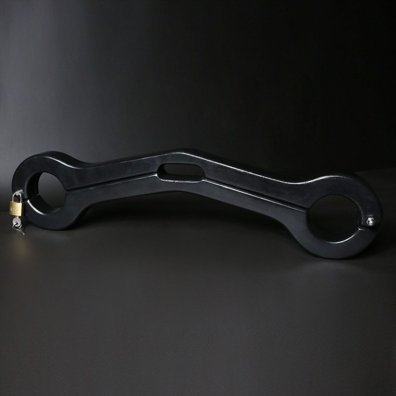 Scrotum to arms black wooden pillory